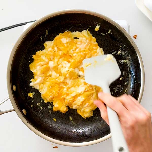 Scrambling the eggs in a skillet.